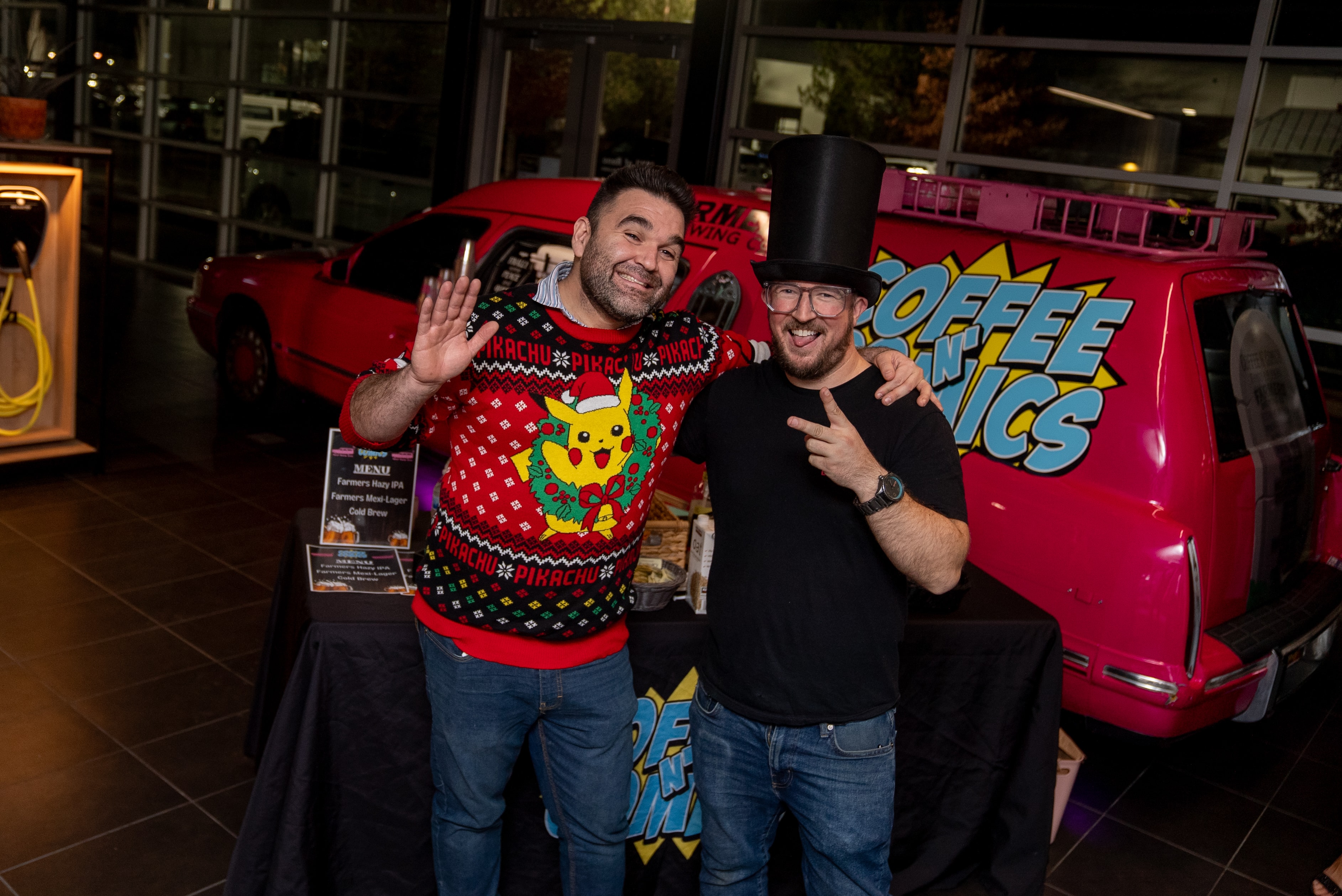 Two men posing with the red food truck