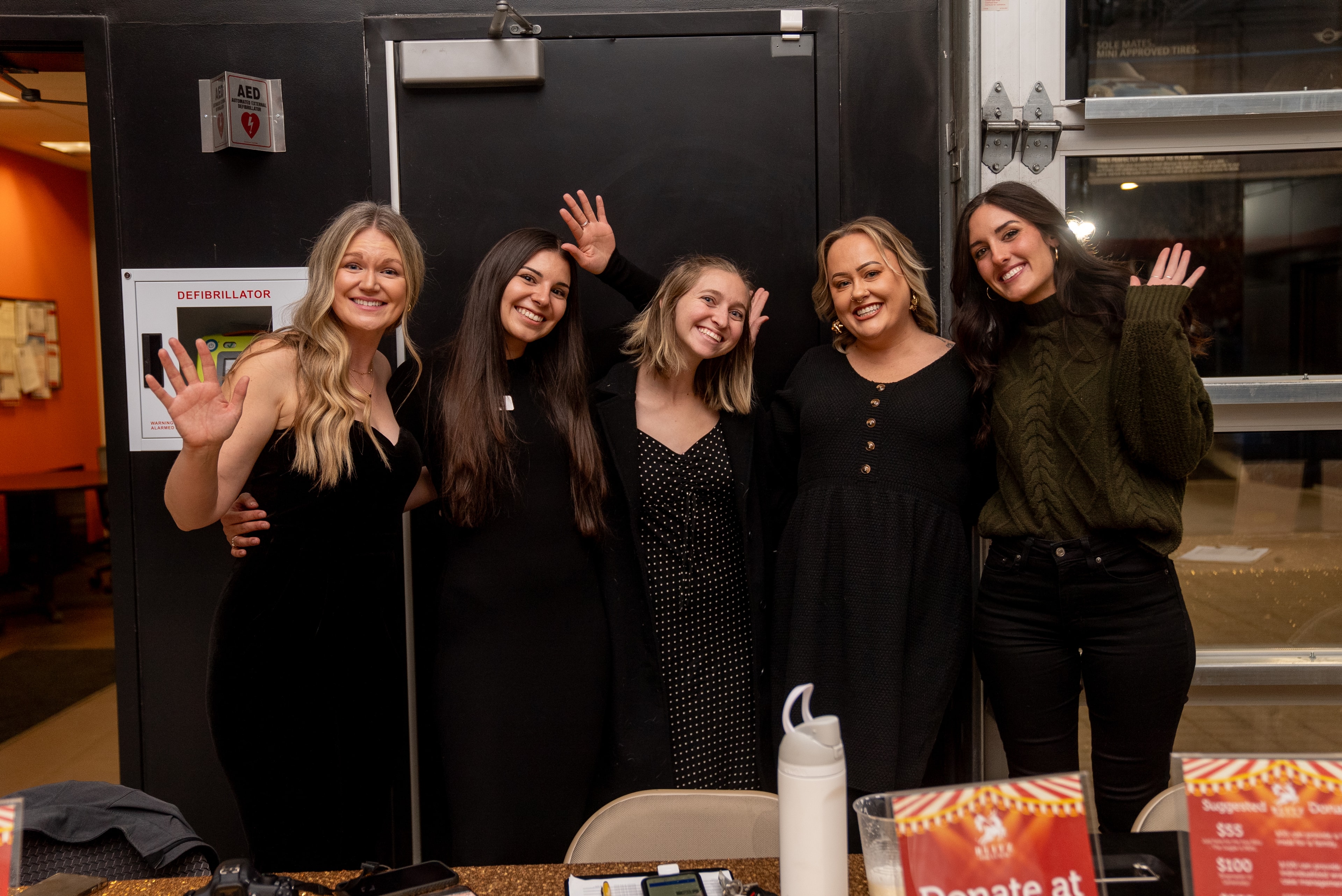Five women waving at the 2024 event