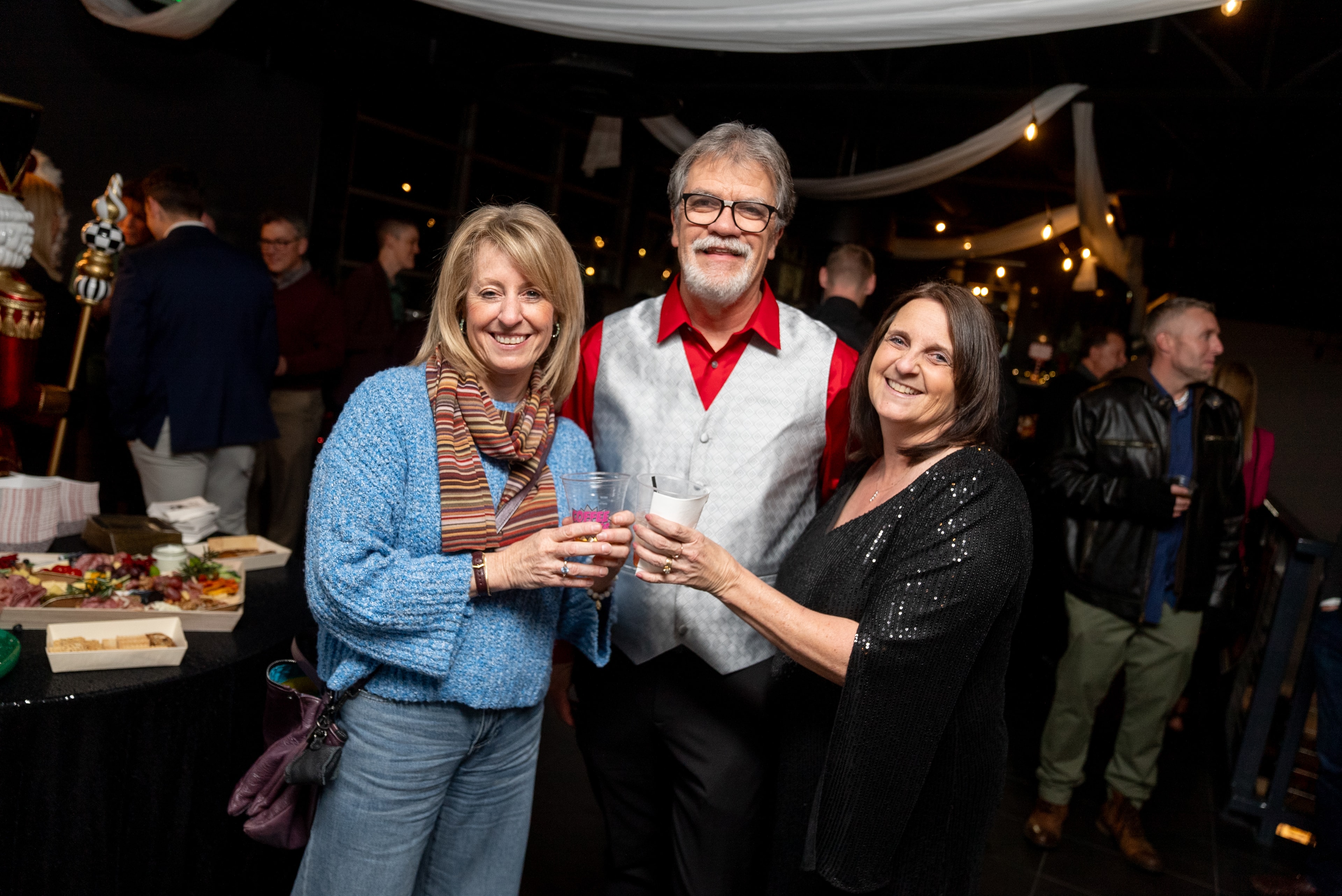 Three people toasting at the evening party