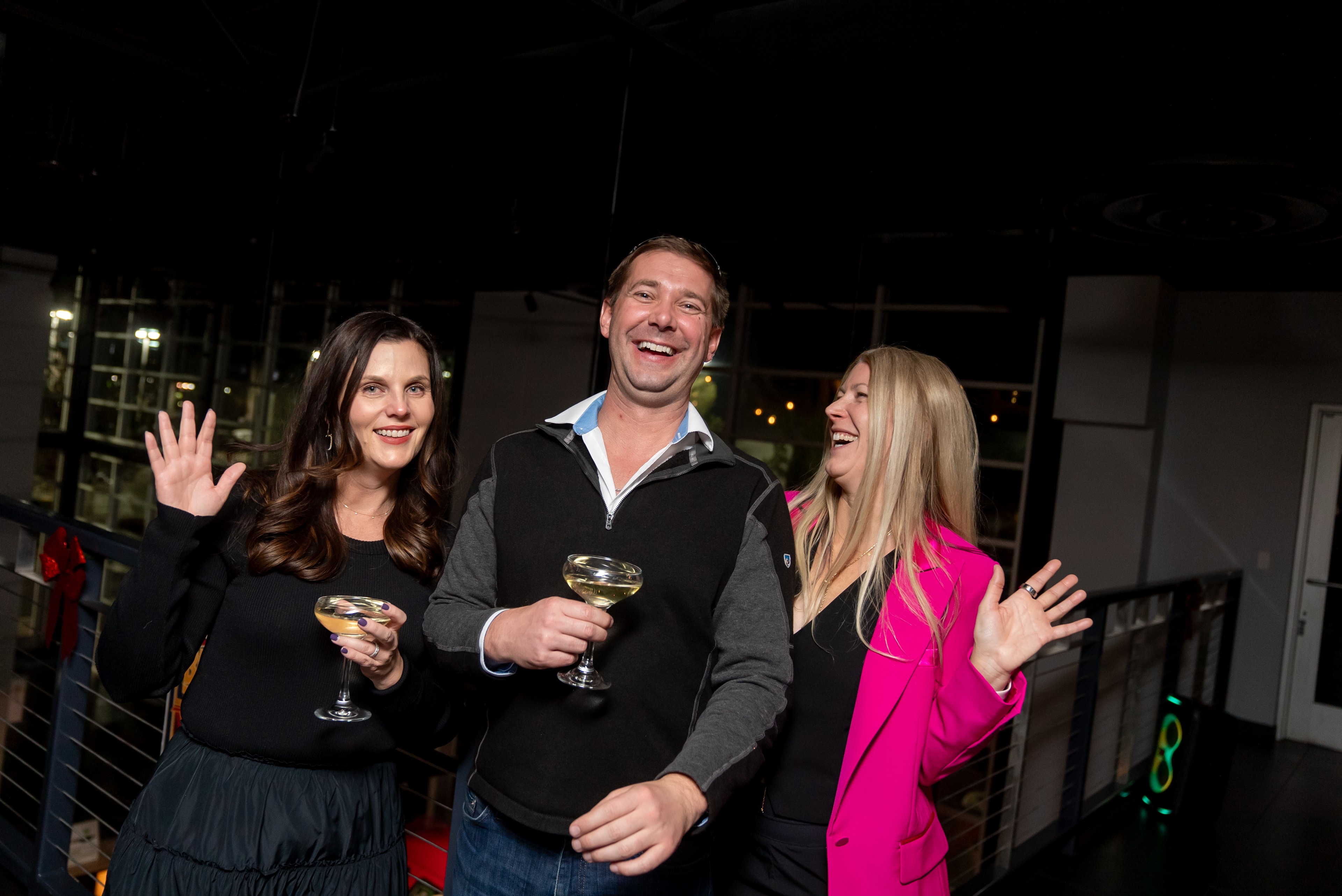 Three friends celebrating with wine glasses