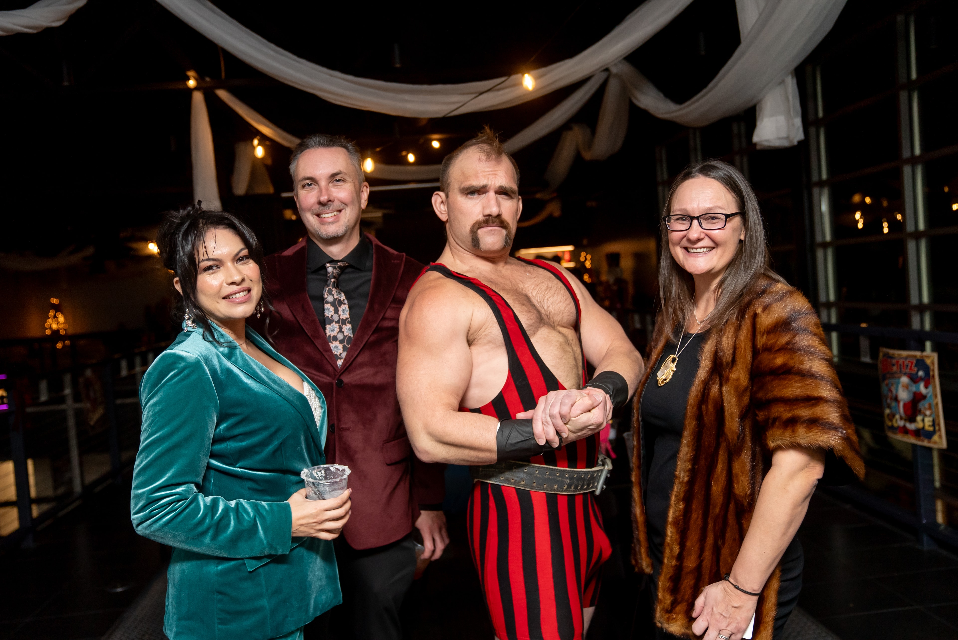 Four people posing at the elegant nighttime event