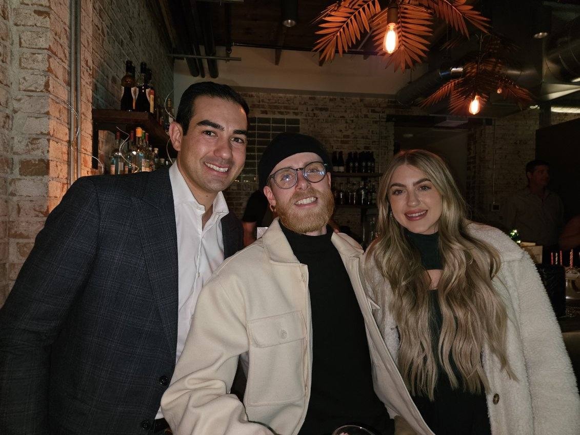 Three friends posing at upscale bar