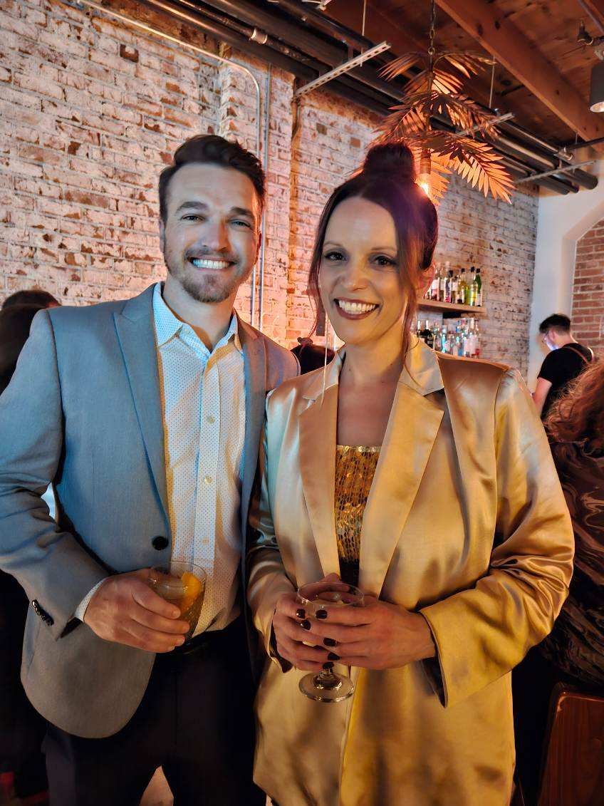 Couple holding drinks at upscale event