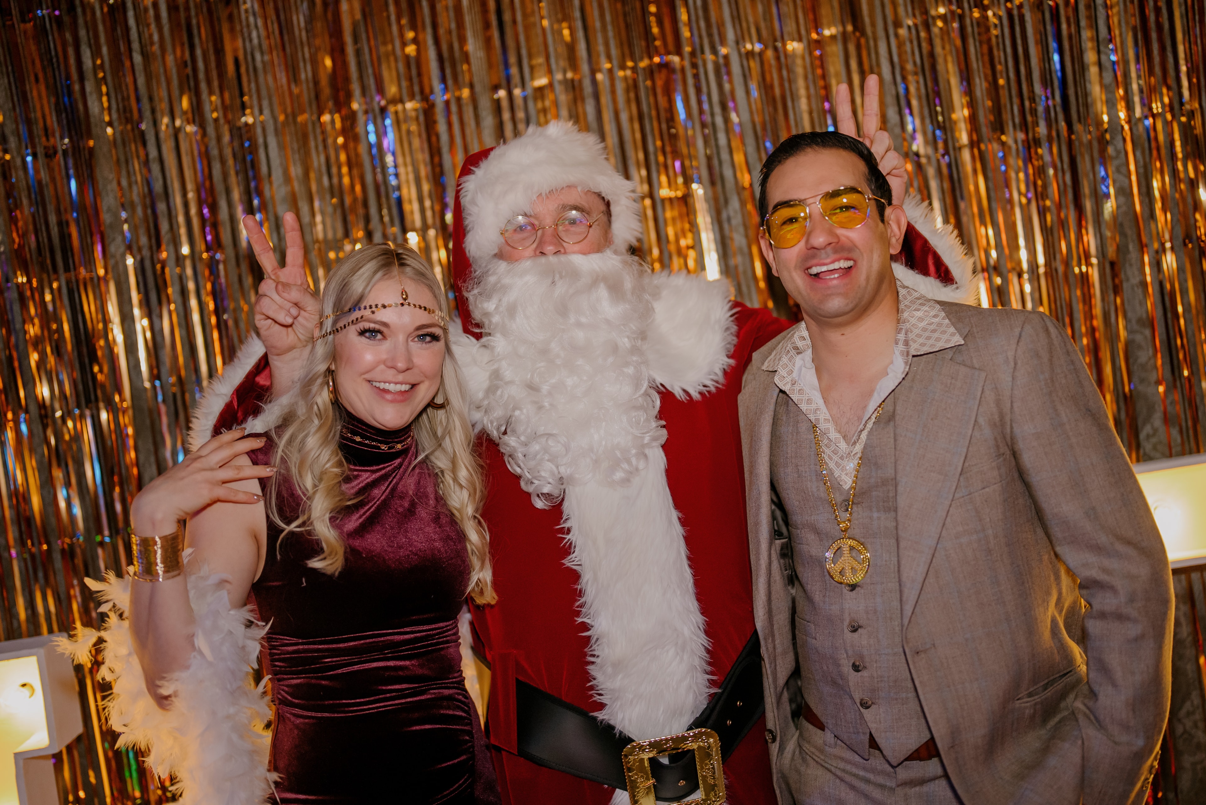 People posing with Santa Claus at party