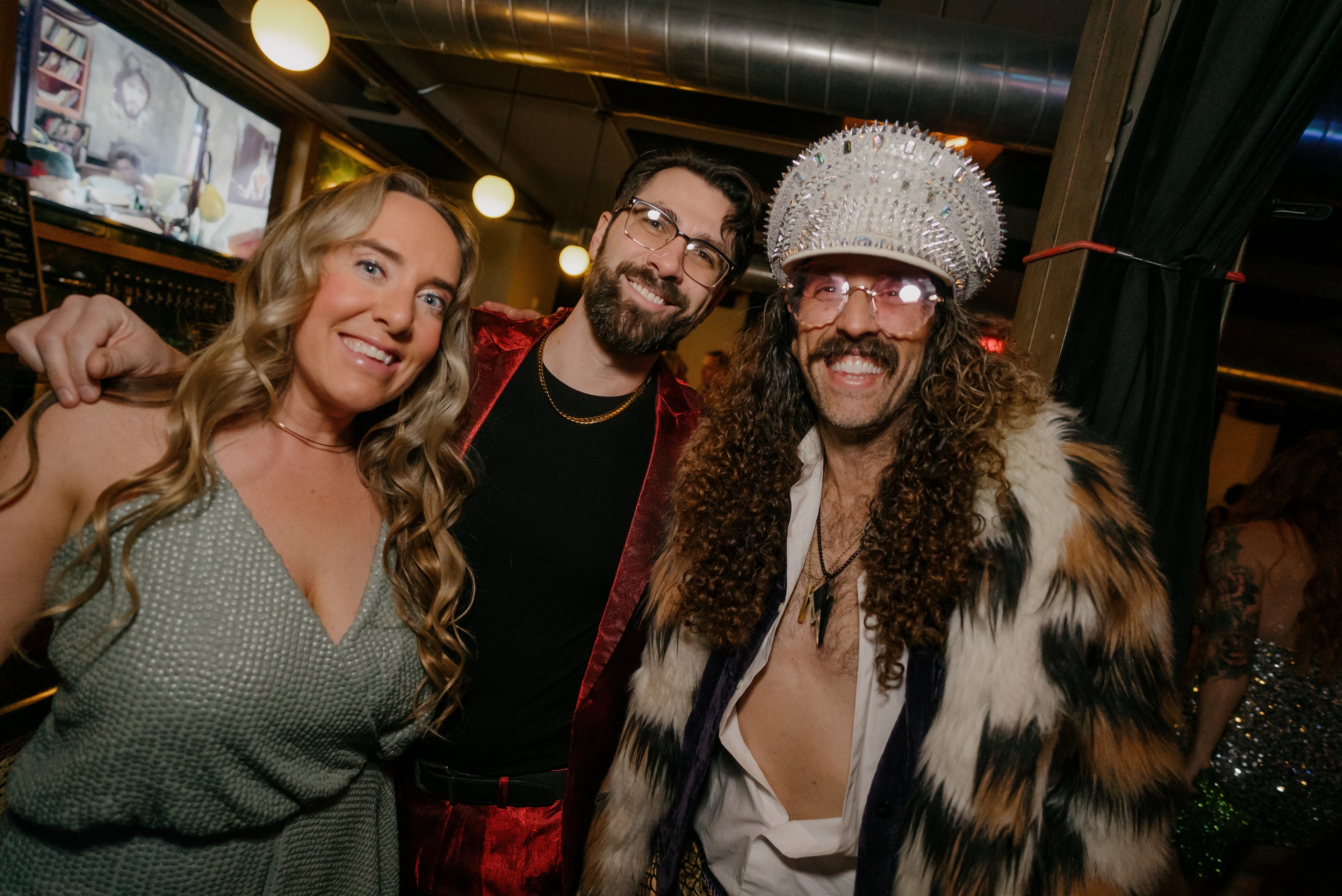 Three friends posing at nightclub party