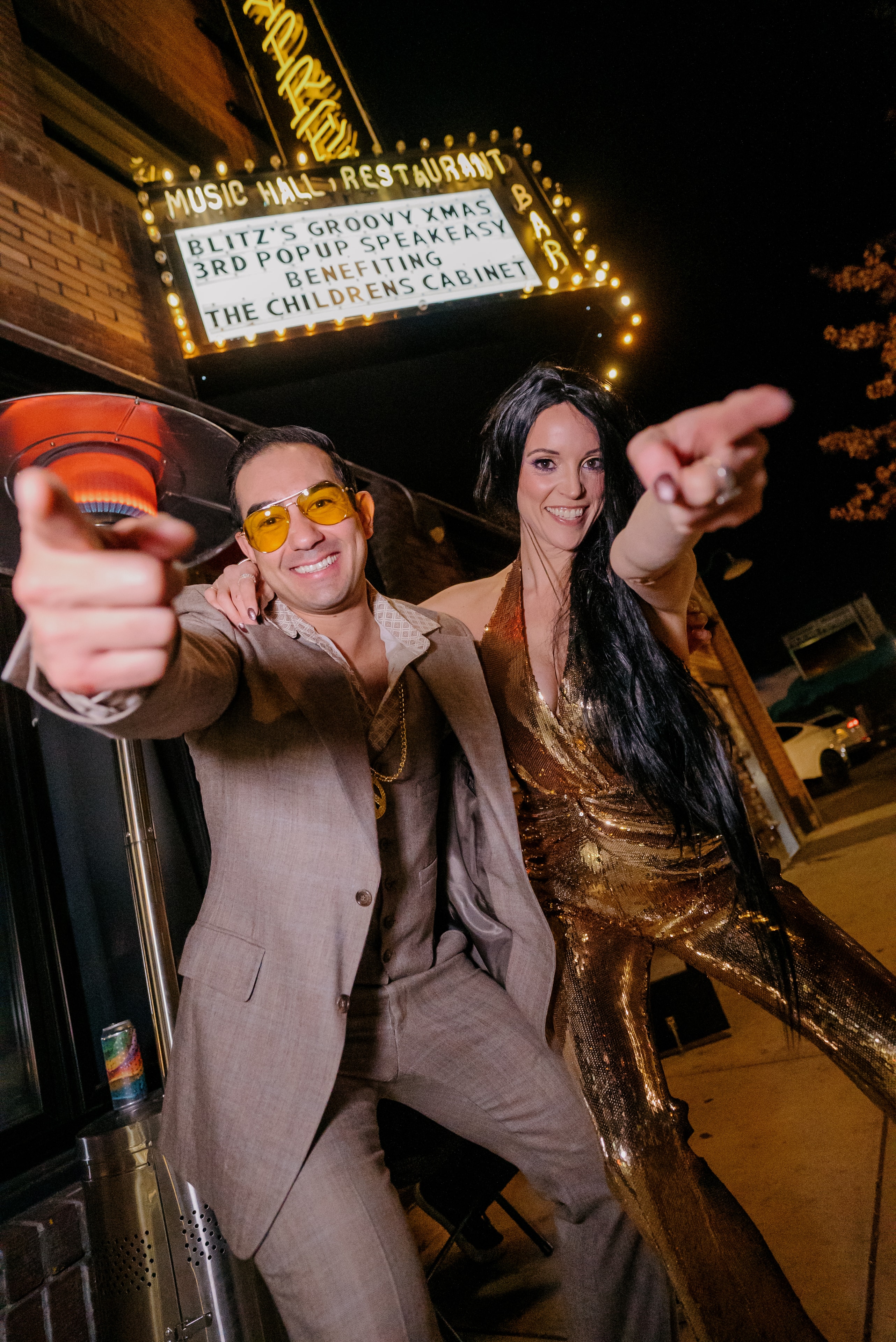 Couple celebrating outside vintage music hall