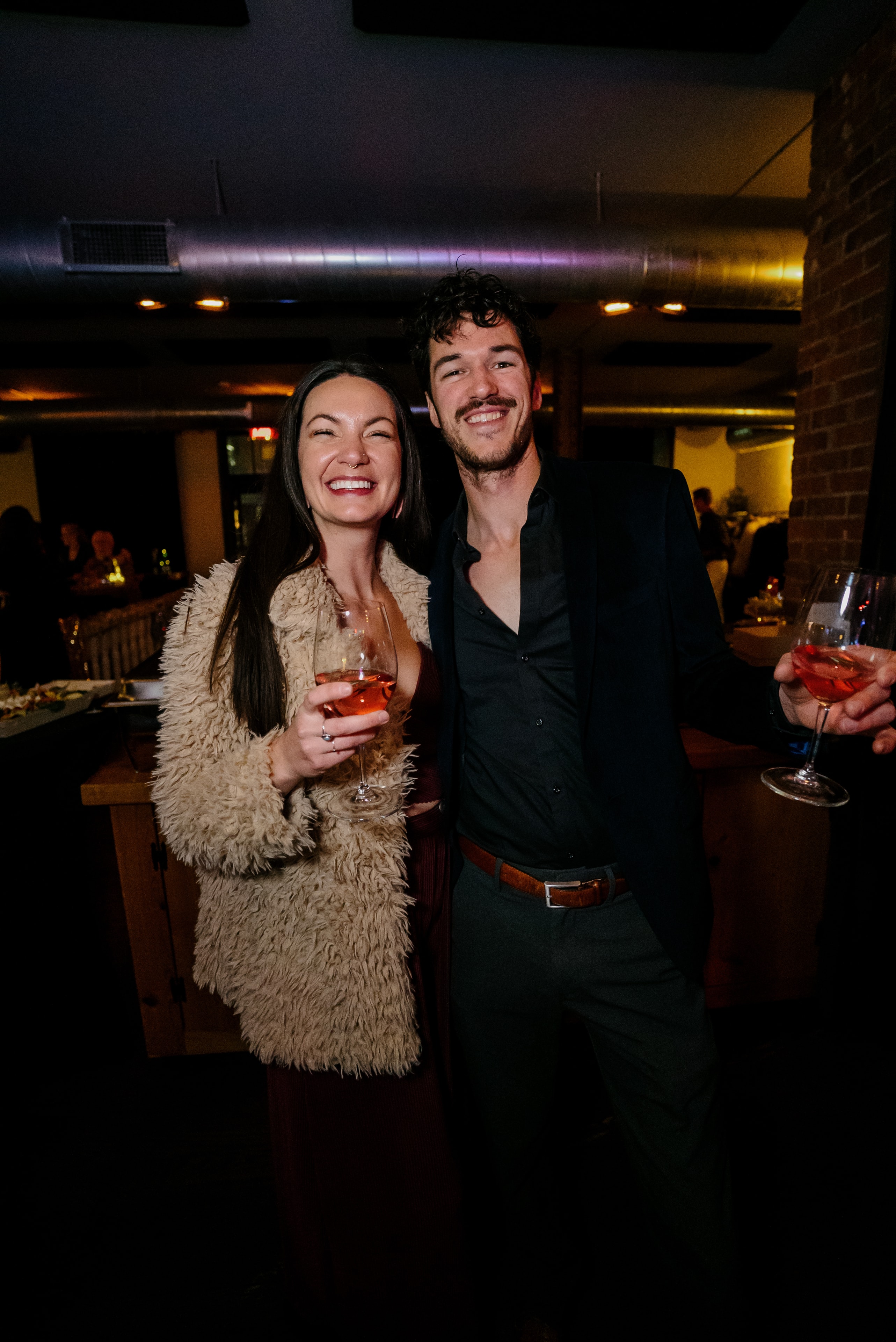 Couple toasting cocktails at nightclub party