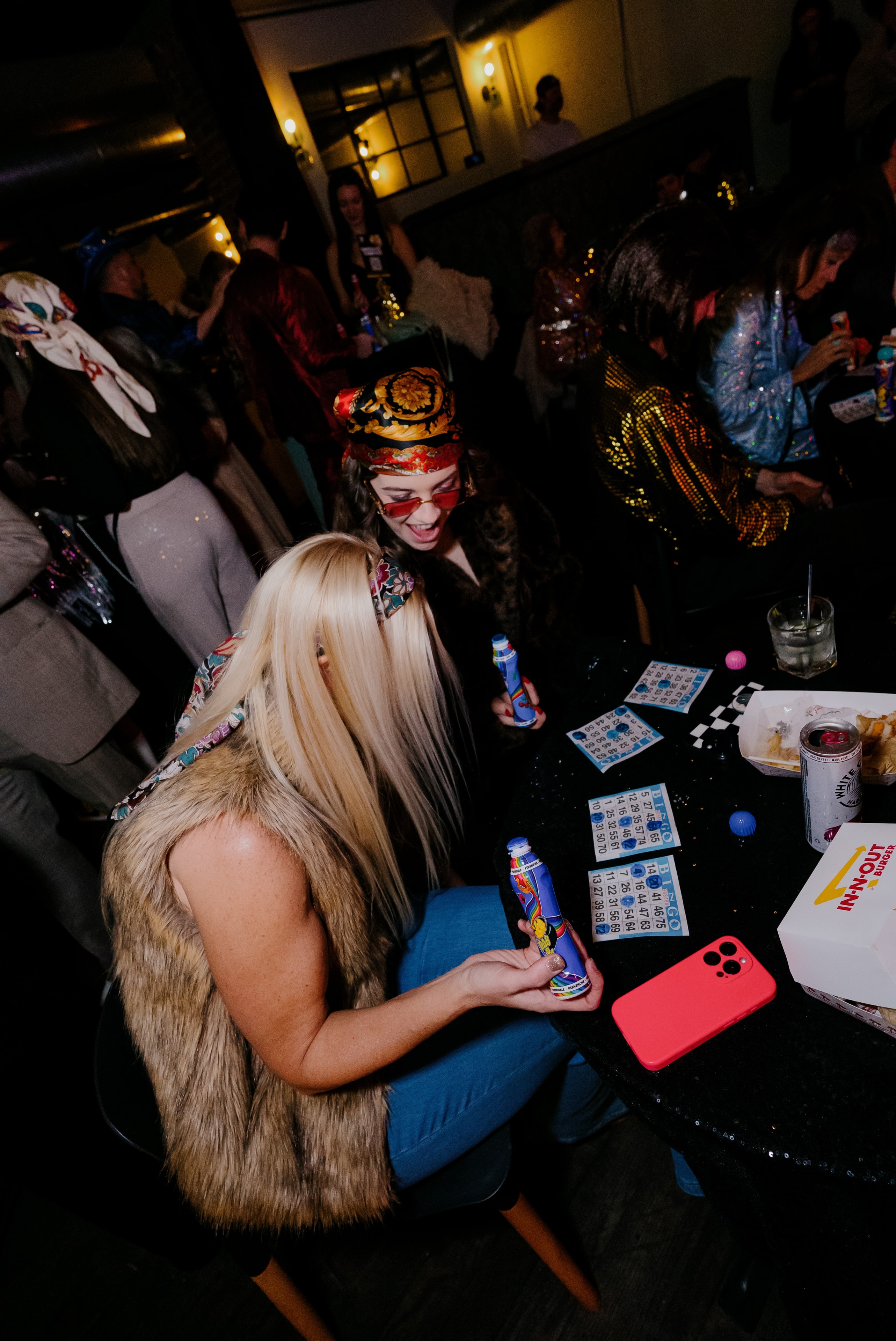 Costumed guests playing bingo at night party