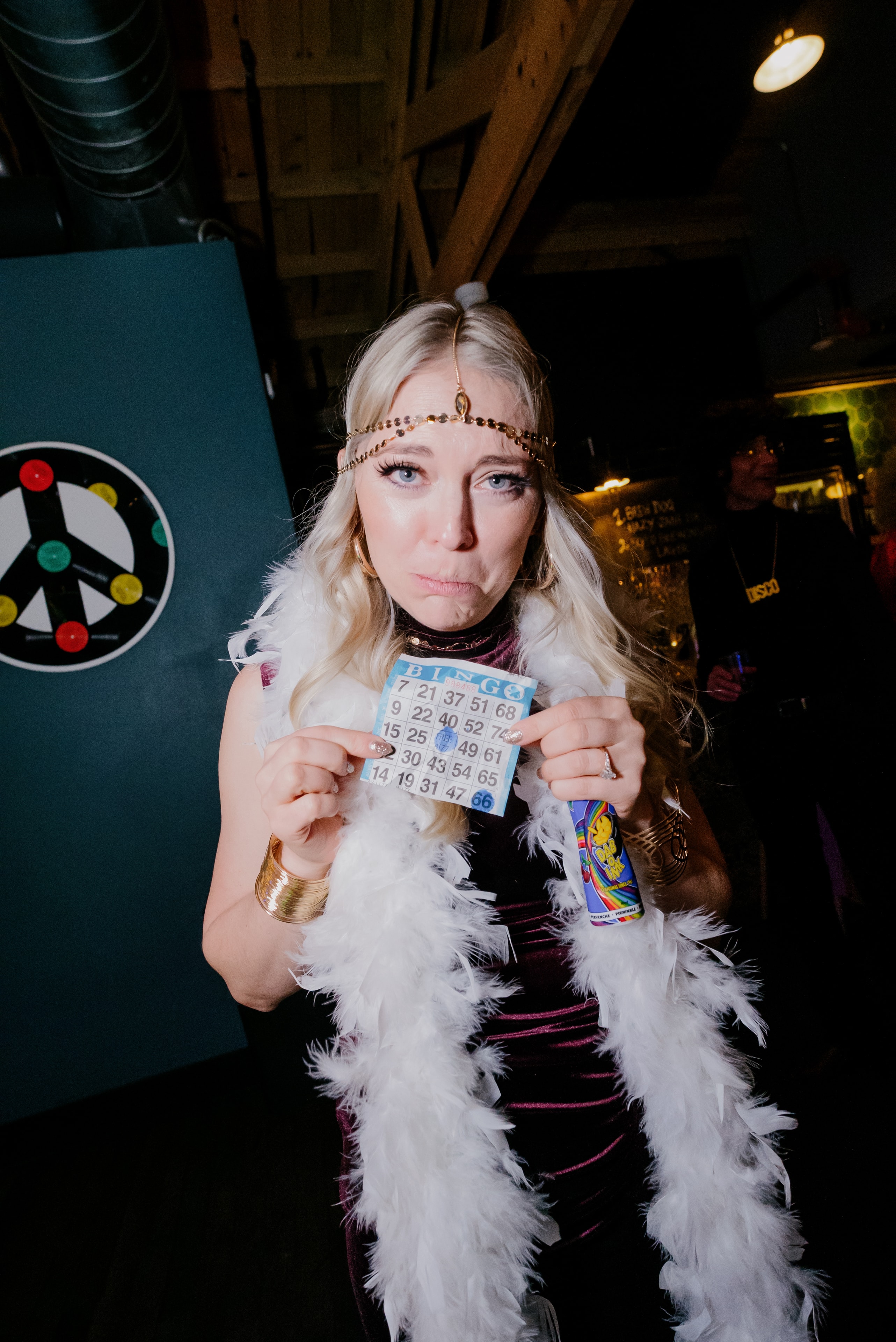 Woman holding bingo card in retro costume